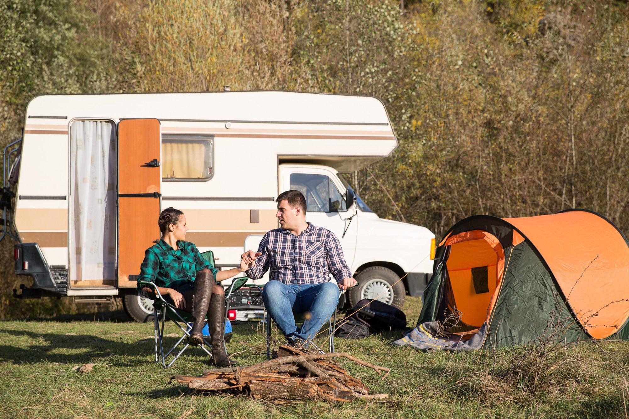 couple sitting by their caravan